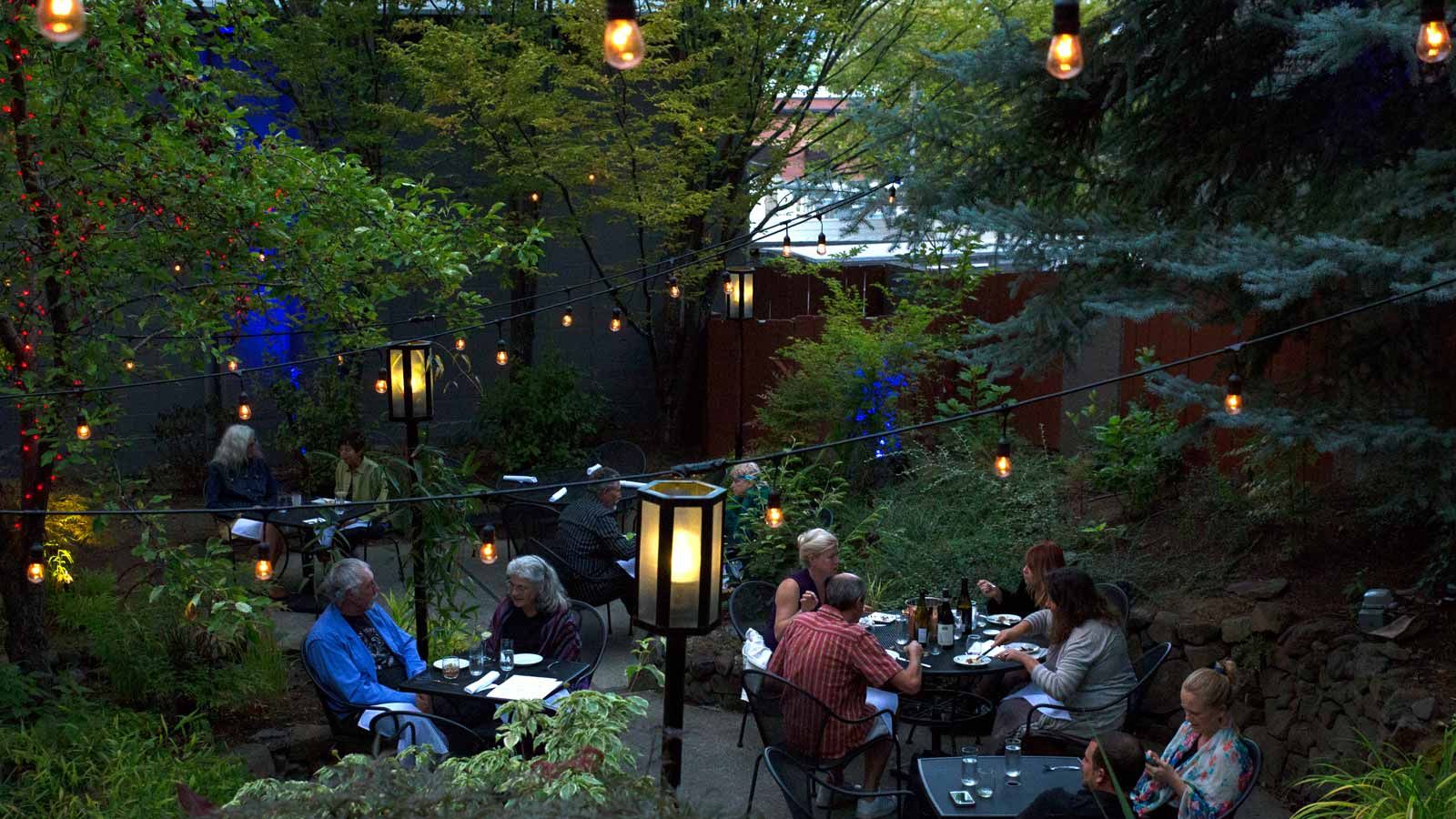 garden patio dining in evening with magical lighting effects